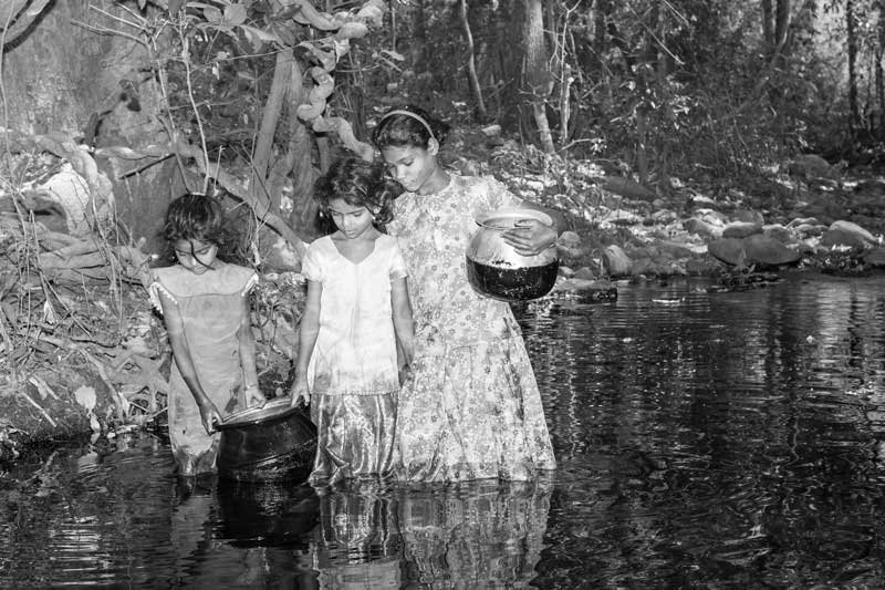 Rural Drinking Water Challenges - girls in a village in Chittoor district, Andhra Pradeshcollecting water from a hilly forest stream, due to absence of a drinking water source in their settlement